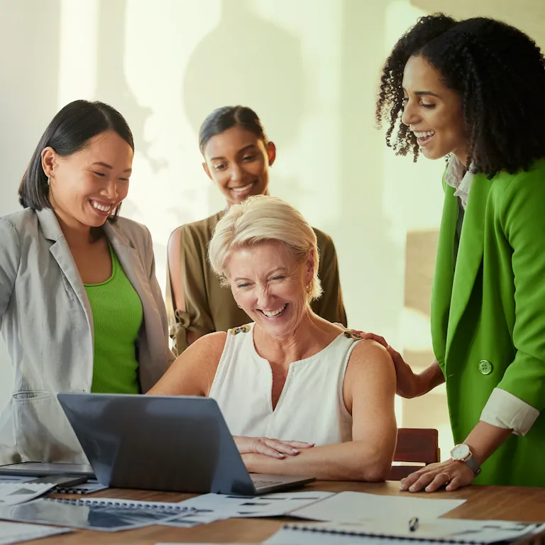 People working together looking at a laptop