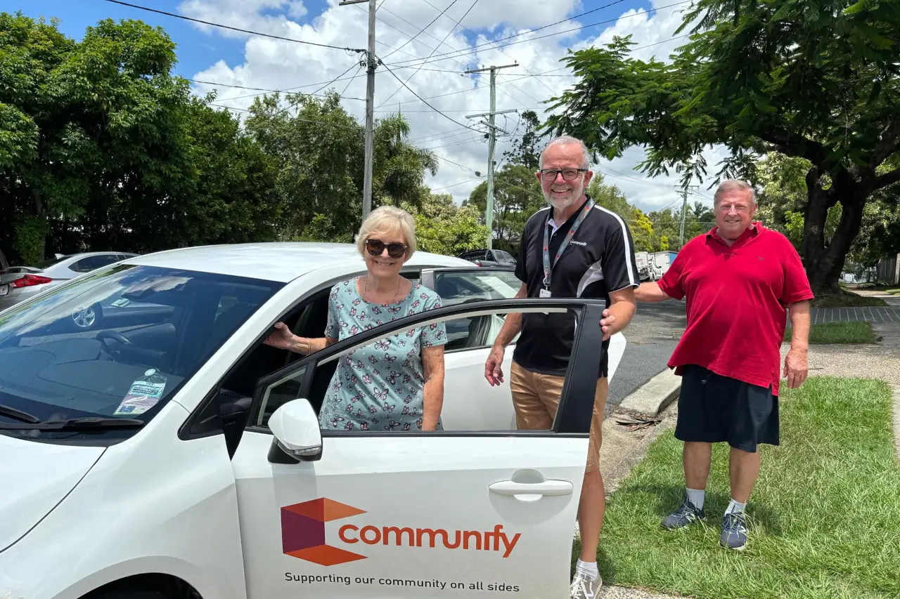 Communify team in front of Communify subsidised transport services car